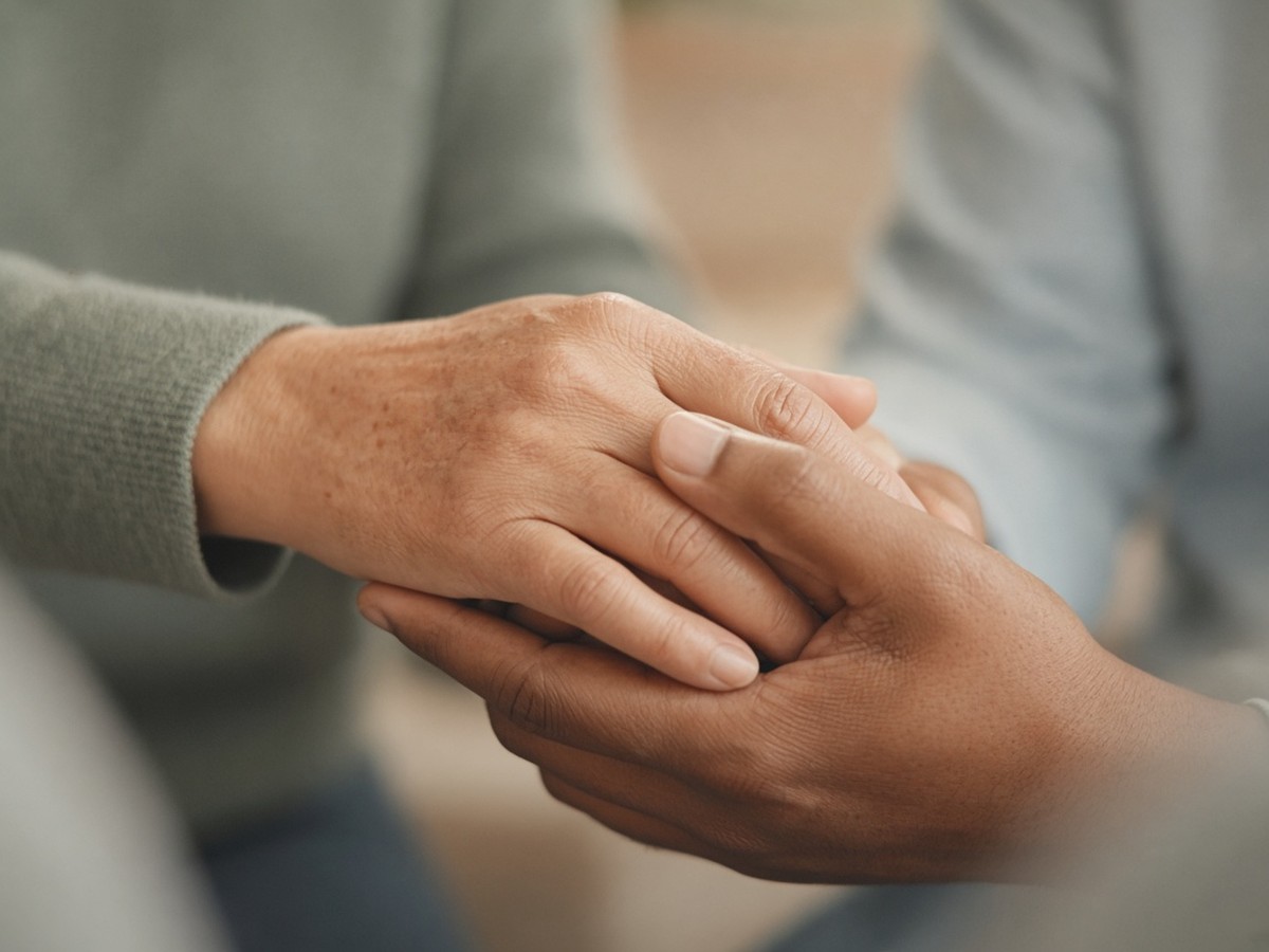 Two people holding hands in a moment of connection